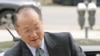 New head of the World Bank and former Dartmouth College president, Jim Yong Kim, reaches out to shake hands as he arrives for meetings at the bank's headquarters in Washington, April 11, 2012. 