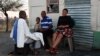 A South African miner and his family sit outside their home in Marikana, September 9, 2012.