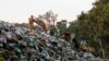 A bulldozer moves piles of garbage in Karantina, east Beirut, Lebanon, Nov. 1, 2015.