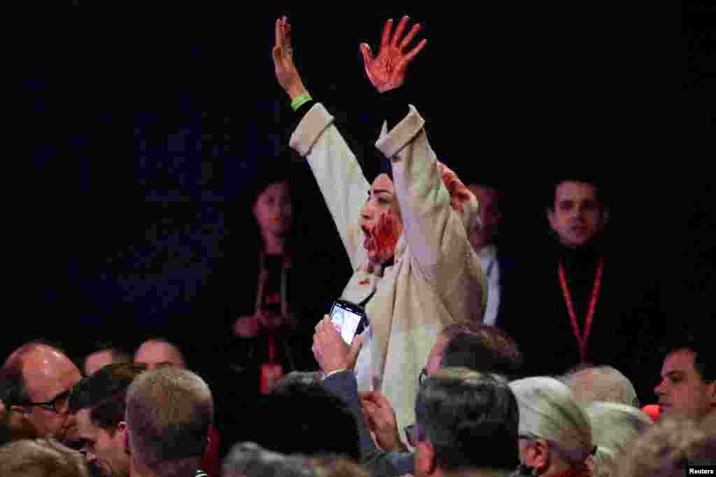 A protester shouts "Free Palestine," as German Chancellor Olaf Scholz visits a former locomotive shed and meets local citizens during the start of his Social Democratic (SPD) party election campaign tour, in Bielefeld.