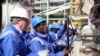 FILE - Ghana's President John Atta Mills turns on the valve to allow the first barrel of crude to flow from the Jubilee offshore oil field.