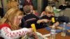 FILE - Idaho Arts Charter School students Maddison Thorpe, left, and Stefan Weiss work on their leather crafts as nationally known leather artist Deana Attebery shows the students the different kinds of tools of the trade in Nampa, Idaho, Dec. 9, 2008. The school received a National Endowment for the Arts grant to hold a series of folk arts after-school enrichment classes for at risk youths. 