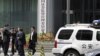 FILE - A police vehicle is seen parked outside a building in Beijing, July 9, 2015.
