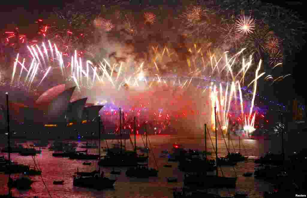 Fireworks light up the Sydney Harbour Bridge and Sydney Opera House during new year celebrations on Sydney Harbour, Australia, Jan. 1, 2018.