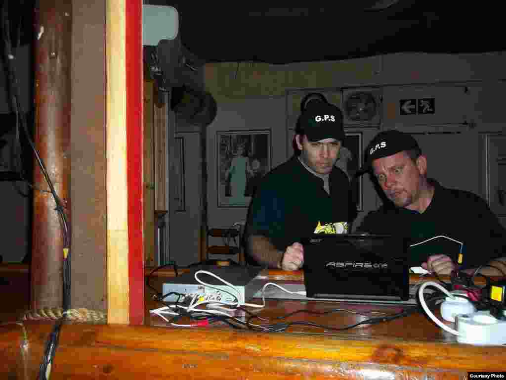 Paranormal experts load evidence into a computer at a restaurant in Pretoria
