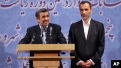Former Iranian President Mahmoud Ahmadinejad, left, and his close ally Hamid Baghaei attend a press conference after registering his candidacy for the upcoming presidential election, at the election headquarters of the interior ministry, in Tehran, Iran,