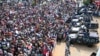 People rally before security forces' vehicles at a mass demonstration near the presidential palace in Sudan's capital, Khartoum, Sept. 12, 2019.