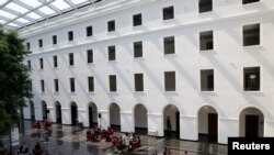 FILE - People are pictured in the headquarters of the World Trade Organization in Geneva, Switzerland, April 12, 2017. 