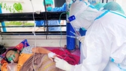 Volunteers treat a coronavirus (COVID-19) patient in the town of Kale
