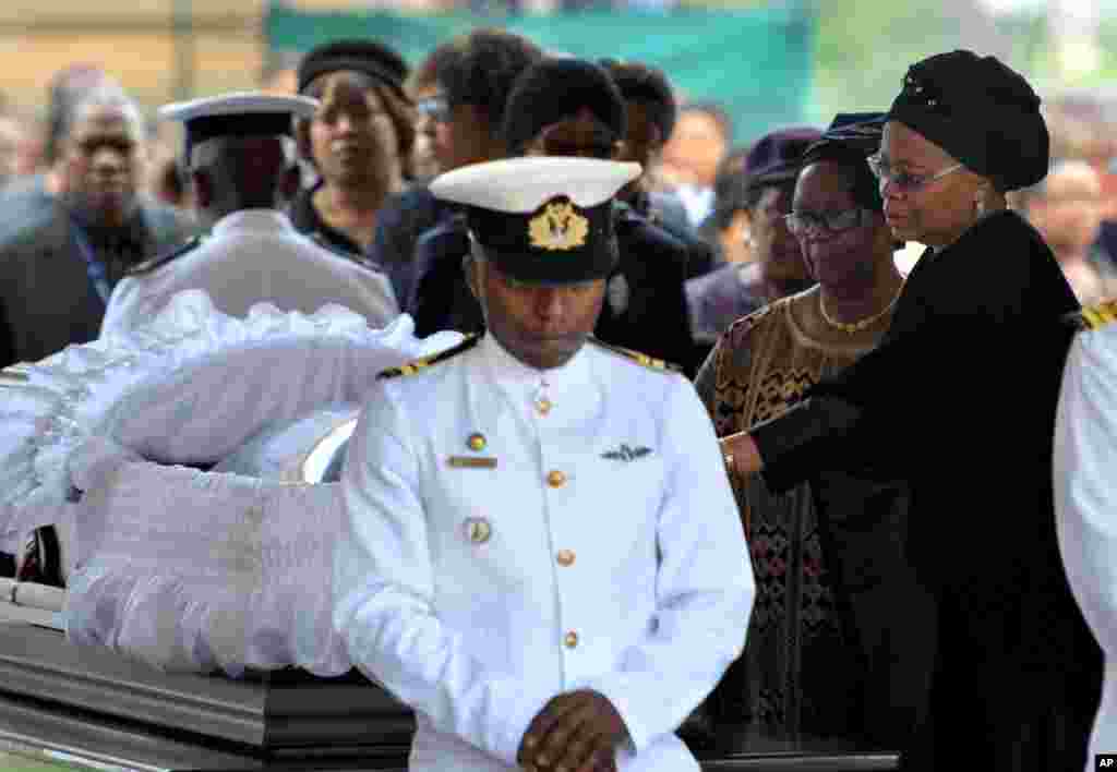 Nelson Mandela's widow Graca Machel, right, pays her respects to the former South African president at the Union Buildings in Pretoria, Dec. 11, 2013.