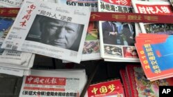 A front page of a Chinese newspaper with a photo of U.S. President-elect Donald Trump and the headline "Outsider counter attack" is displayed at a newsstand in Beijing, China, Thursday, Nov. 10, 2016. Trump is a mixed blessing for Chinese leaders. His threats to tear up trade deals and hike tariffs on Chinese goods could chill thriving commercial ties when Beijing is struggling to shore up economic growth. At the same time, Trump’s suggestion he might reduce Washington’s global strategic presence to focus on domestic issues would be a gift to Chinese leaders. They could expand their political and military profile in East Asia with less risk of conflict. (AP Photo/Ng Han Guan) 长征 中国梦