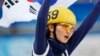 Shim Suk-hee of winner South Korea's skating team celebrates and holds up her national flag after the women's 3,000 meters short track speed skating relay final event at the Sochi 2014 Winter Olympic Games on February 18, 2014. 
