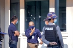 Bullet holes are seen on the window at American Center in Yangon, Myanmar, March 27, 2021.