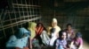 Samsun Nahar, a Rohingya widow, and her 9 children in their bamboo-and-plastic shack in a refugee colony in Kutupalong, Cox’s Bazar, Bangladesh. Nahar is looking for grooms for her 13 and 14-year old daughters. (Photo by Noor Hossain)