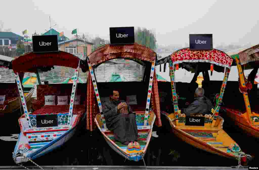 Uber signs are displayed on "Shikaras" or small boats after Uber launched its first water transport service on the waters of Dal Lake, one of Kashmir's main tourist attractions, in Srinagar, India.