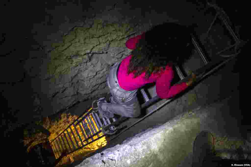 A girl climbs the ladder leading to the burial chambers located 7 meters under ground, in Luxor, Egypt, Sept. 9, 2017.