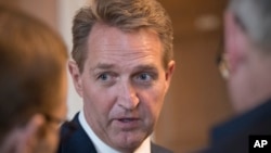 Sen. Jeff Flake, R-Ariz., takes questions from reporters at the Capitol in Washington, Jan. 4, 2018. 