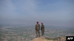FILE - Afghan National Army (ANA) soldiers keep watch in Dand-e-Ghori district in Baghlan province on March 15, 2016, following weeks of heavy battles to recapture the area from Taliban militants.