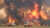 FILE - Firefighters try to protect homes around Charmhaven, New South Wales, in this image dated Dec. 30, 2019, and provided by NSW Rural Fire Service via their twitter account.