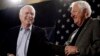 FILE - Sen. John McCain, R-Ariz., left, smiles as he gets a pat on the back from longtime friend and supporter Lt. Col. Orson Swindle, USMC Ret., Feb. 18, 2010, at a rally in Phoenix, Arizona.