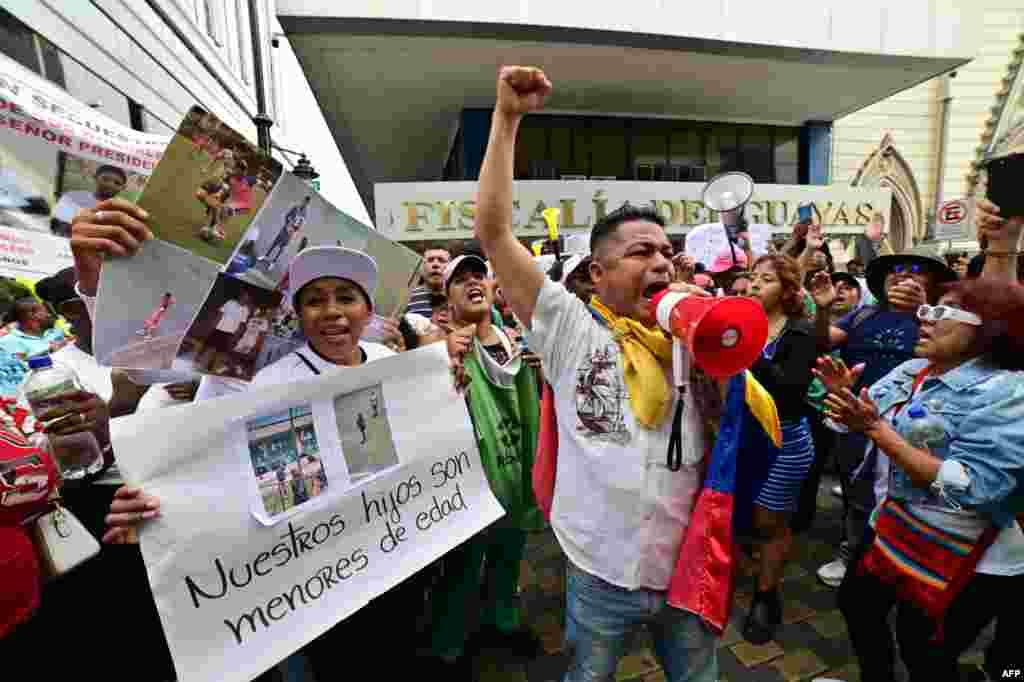 People demonstrate against the disappearance of four adolescent boys who went missing during a military operation two weeks ago while they were out playing football, in front of the prosecutor's office in Guayaquil, Ecuador.