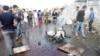 People gather at the site of suicide blasts in Baghdad's Sadr City, Feb. 28, 2016. The death toll from two suicide blasts in Baghdad's mainly Shi'ite district of Sadr City rose to 24 with more than 60 others wounded, police and medical sources said.