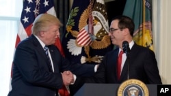 President Donald Trump shakes hands with Treasury Secretary Steven Mnuchin at the Treasury Department in Washington, April 21, 2017.