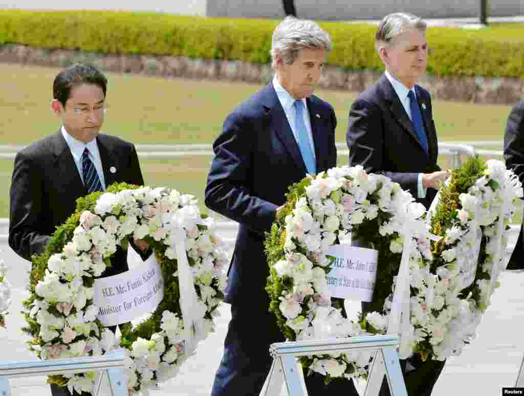 U.S. Secretary of State John Kerry (2nd L) prepares to lay a wreath at the cenotaph with Japan's Foreign Minister Fumio Kishida (L), Britain's Foreign Minister Philip Hammond and other fellow G7 foreign ministers at Hiroshima Peace Memorial Park and Museum in Hiroshima, in this photo released by Kyodo April 11, 2016.