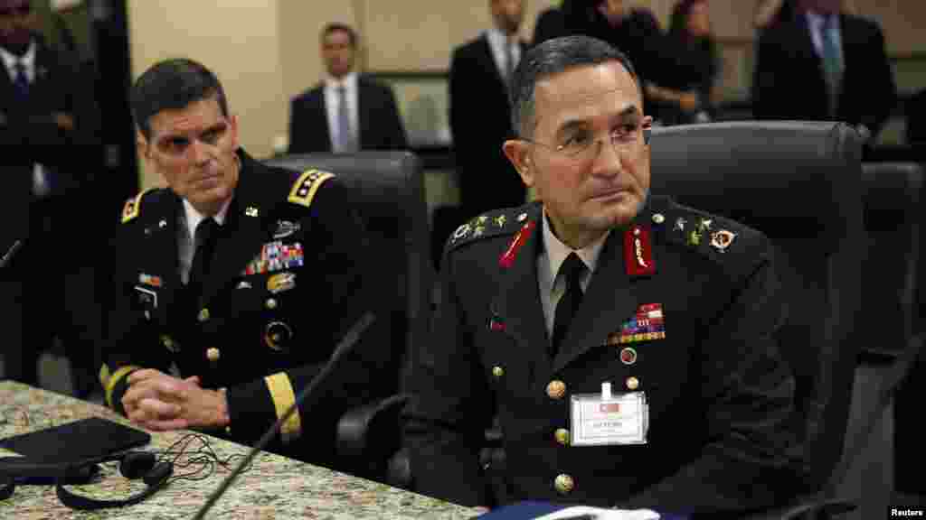 Turkish Lieutenant General Erdal Ozturk, right, and head of US Special Operations Command General Joseph Votel, left, listen as U.S. President Barack Obama (not pictured) speaks at Joint Base Andrews in Washington, Oct. 14, 2014.