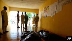 FILE - Family members wait to claim bodies of suicide attack victims at a hospital in Konduga outside Maiduguri, Nigeria, Aug. 16, 2017. The attack was blamed on Boko Haram militants.