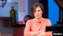 FILE - Amanda Knox sits alone before being interviewed on the set of ABC's "Good Morning America" in New York, Jan. 31, 2014. 