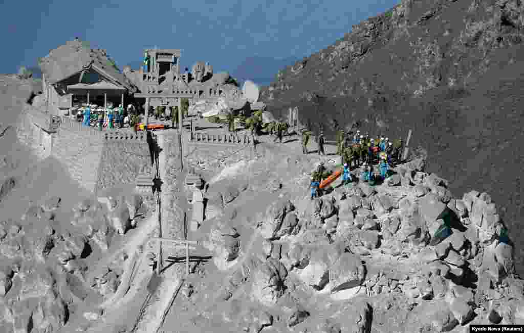 Japan Self-Defense Force (JSDF) soldiers and police officers take part in a rescue operation near the peak of Mount Ontake. More than 500 rescuers resumed the search for victims of the volcano on Monday, central Japan, Sept. 29, 2014.
