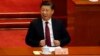 Chinese President Xi Jinping adjusts his jacket during the opening session of the Chinese People's Political Consultative Conference (CPPCC) held in Beijing, China, March 3, 2017. 