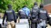 FILE - Special police investigate the Hezbollah-linked Imam Mahdi center in Muenster, western Germany, April 30, 2020.
