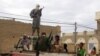 FILE - In this Aug. 31, 2012 file photo, fighters from Islamist group Ansar Dine stand guard in Timbuktu 