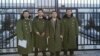 在“法制教育基地”前的四位律师(左起：江天勇、张俊杰、王成、唐吉田, 网络图片)