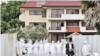 Thai medical staff stand in front of a facility at the Satthahip Naval Base, where Thai citizens who were evacuated from Wuhan, China, are quarantined for 14 days after their arrival, Feb. 4, 2020.