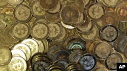 FILE - Bitcoin tokens at software engineer Mike Caldwell's shop in Sandy, Utah, April 3, 2013. 