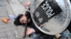 FILE - Police arrest a protester after a Chinese flag was removed from a pole at a rally in support of Xinjiang Uighurs' human rights in Hong Kong, China, Dec. 22, 2019.