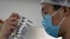 CHINA -- A worker inspects syringes of a vaccine for COVID-19 produced by Sinovac at its factory in Beijing, September 24, 2020.
