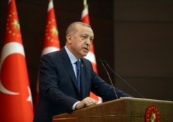 FILE - Turkish President Tayyip Erdogan talks during a news conference following a coronavirus disease (COVID-19) meeting in Ankara, March 18, 2020.