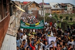 FILE - Kashmiri men shout slogans during a protest after the scrapping of the special constitutional status for Kashmir by the Indian government, in Srinagar, Aug. 11, 2019.