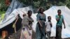 Perempuan dan anak-anak di sebuah kamp pengungsi Ethiopia dari kelompok etnis Qemant di desa Basinga, distrik Basunda, wilayah Gedaref timur Sudan, 10 Agustus 2021. (Foto: ASHRAF SHAZLY / AFP)
