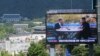 A TV screen shows a photo of South Korean President Moon Jae-in and North Korean leader Kim Jong UN, right, to advertise upcoming Seoul Defense Dialogue in Seoul, South Korea, Sept. 5, 2018. The sign read: "Peace on the Korea Peninsula."