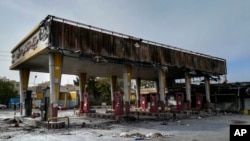 This photo released by the Iranian Students' News Agency, ISNA, shows a gas station that was burned during protests that followed authorities' decision to raise gasoline prices, in Tehran, Iran, Sunday, Nov. 17, 2019. Ayatollah Ali Khamenei, Iran's…