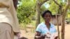 Information teams are chosen from the communities to disseminate information about residual spraying. They go door-to-door explaining the process and when it will take place, Mozambique, Nov. 13, 2014. (Gillian Parker/VOA)