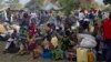FILE - Refugees from eastern Democratic Republic of Congo (DRC) wait at the Busunga border in western Uganda, July 2013.
