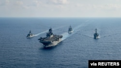 Royal Australian Navy guided-missile frigate HMAS Parramatta (FFH 154) (L) sails with U.S. Navy Amphibious assault ship USS America (LHA 6), Ticonderoga-class guided-missile cruiser USS Bunker Hill (CG 52) and Arleigh-Burke class guided missile destroyer.