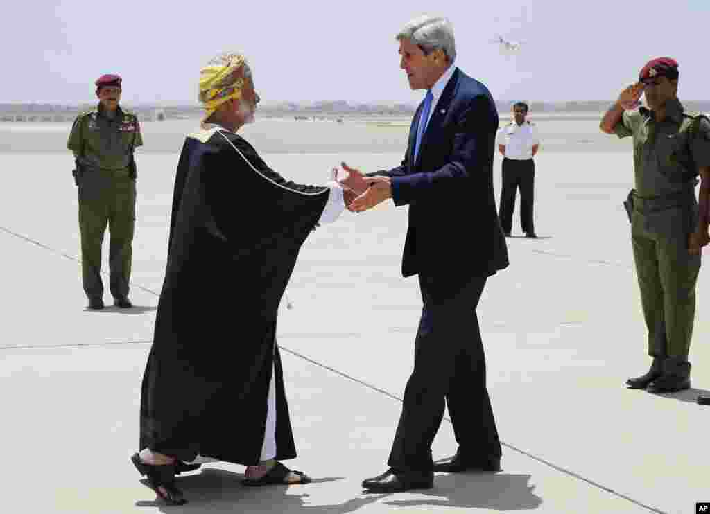 U.S. Secretary of State John Kerry is greeted by Oman's Foreign Minister Yusuf Bin Alawi bin Abdullah in Muscat, Oman, May 21, 2013.