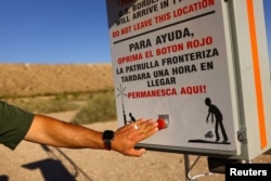 U.S. Border Patrol Agent Fidel Baca shows a "rescue beacon," placed by U.S. Customs and Border Protection in remote areas where migrants can press a red button to request help. This one is near Sunland Park, New Mexico, Oct. 5, 2023.